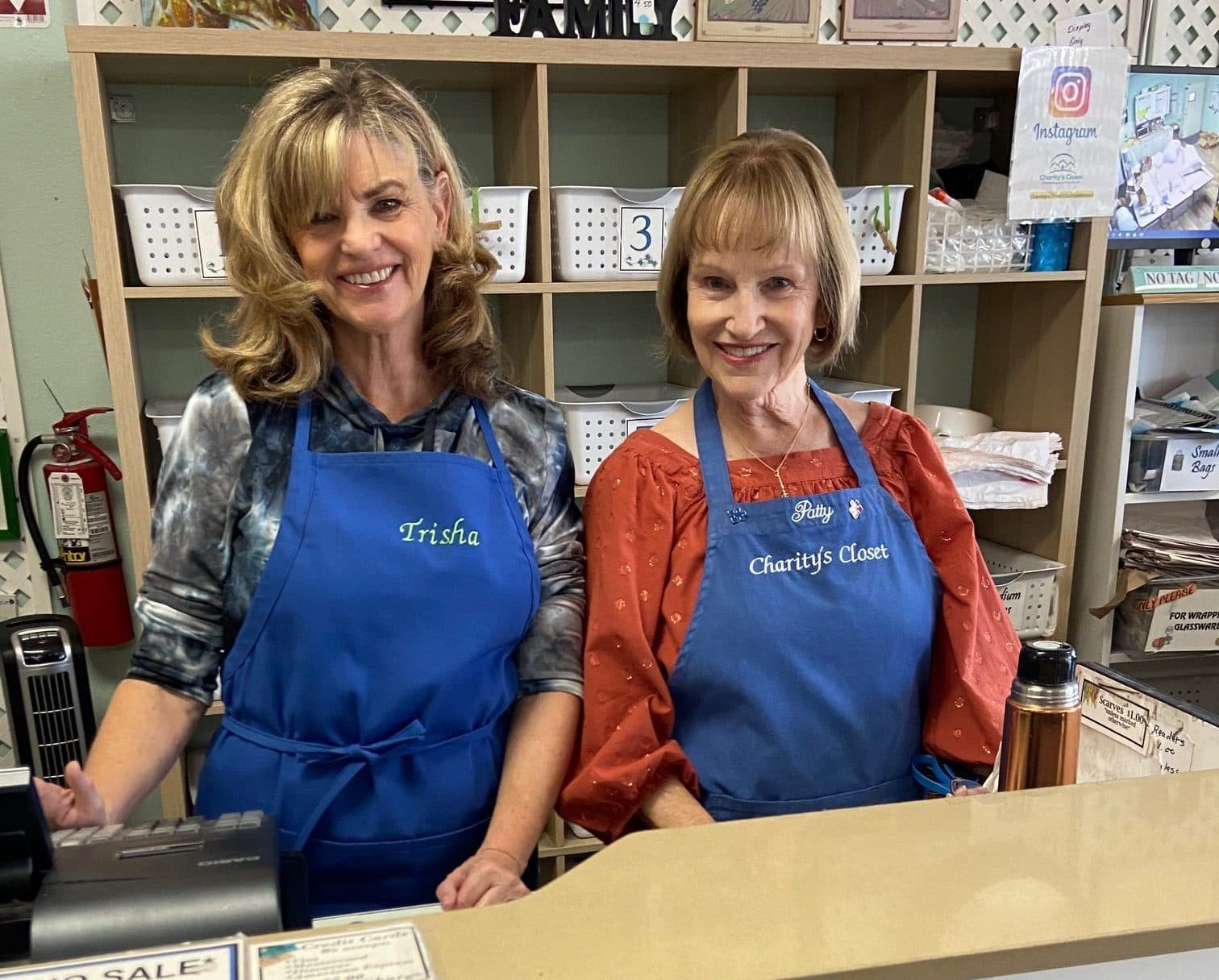 Two smiling Charity’s Closet volunteers at the register